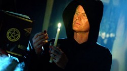 Wiccan with candle and Book of Shadows